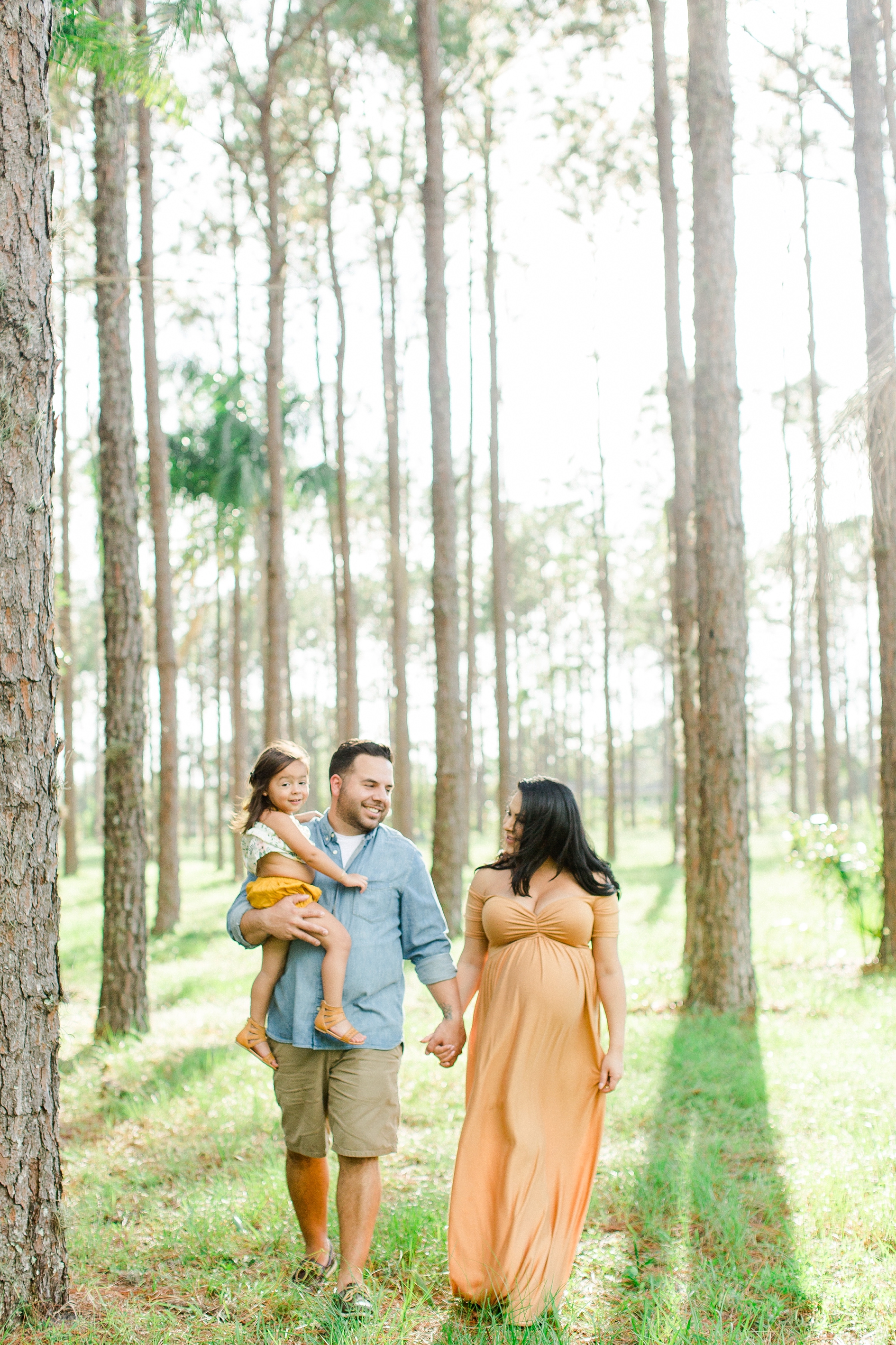 Rustic maternity photos in Tampa Expecting Mom and family in front of barn